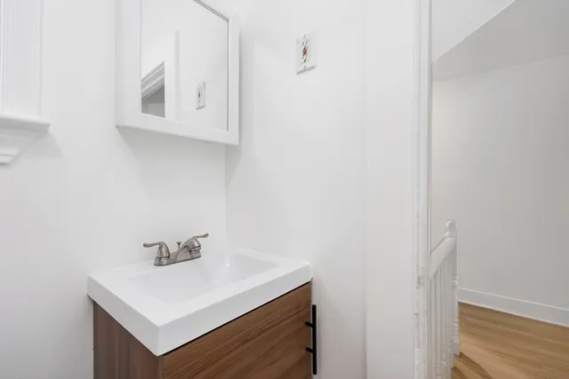 a bathroom with a sink vanity and mirror