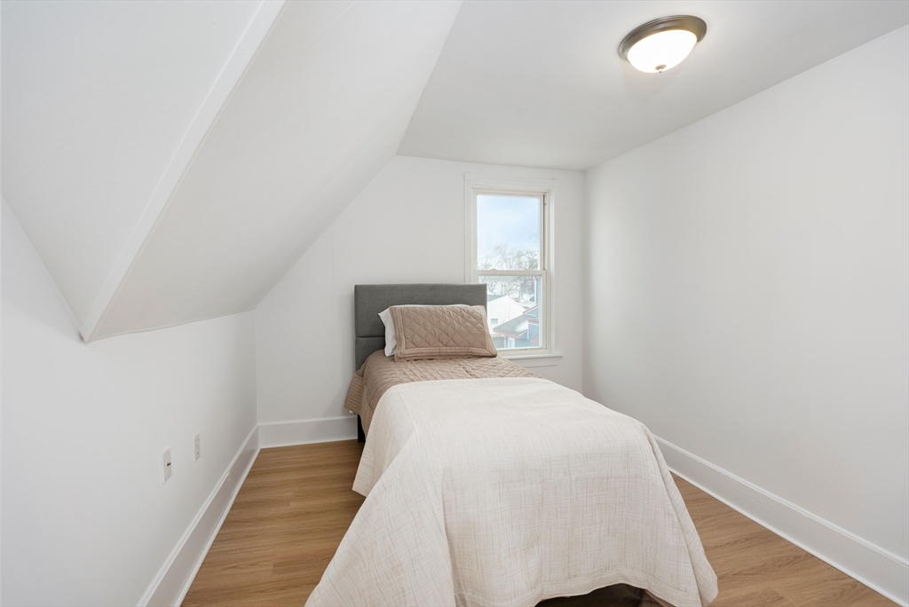 79 Brookline Street Lynn, MA 01902 - Photo 24 of 27 a bed room with a bed and a night stand