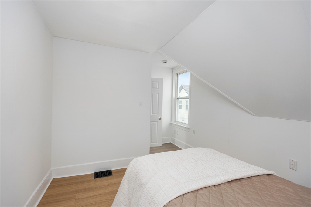 79 Brookline Street Lynn, MA 01902 - Photo 25 of 27 a bedroom with a bed and a window