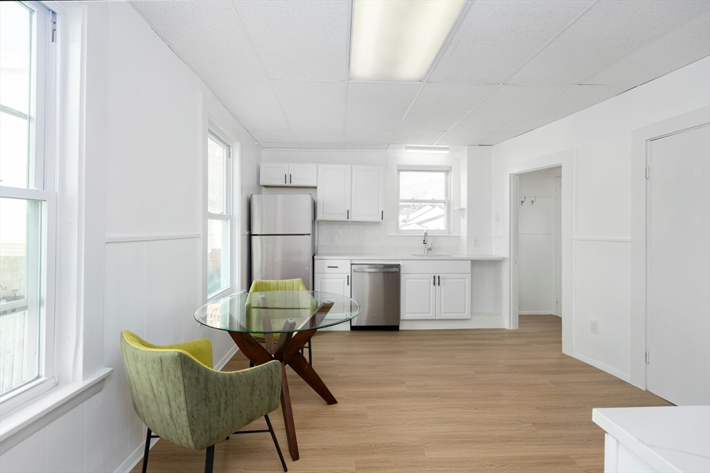 79 Brookline Street Lynn, MA 01902 - Photo 9 of 27 a kitchen with stainless steel appliances wooden floor and a refrigerator