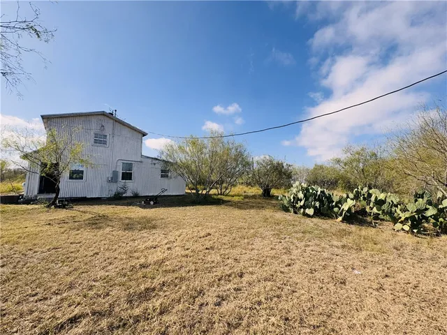 a view of a house with a snow in the yard