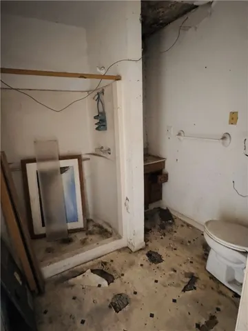 a bathroom with a toilet and a shower