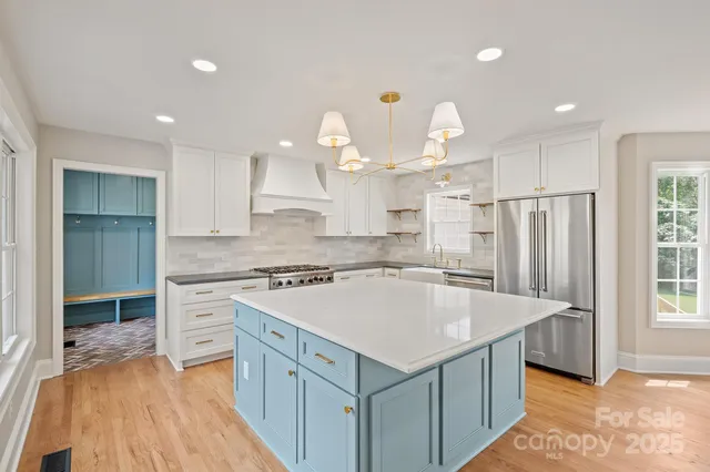 a kitchen with a stove a refrigerator and a sink