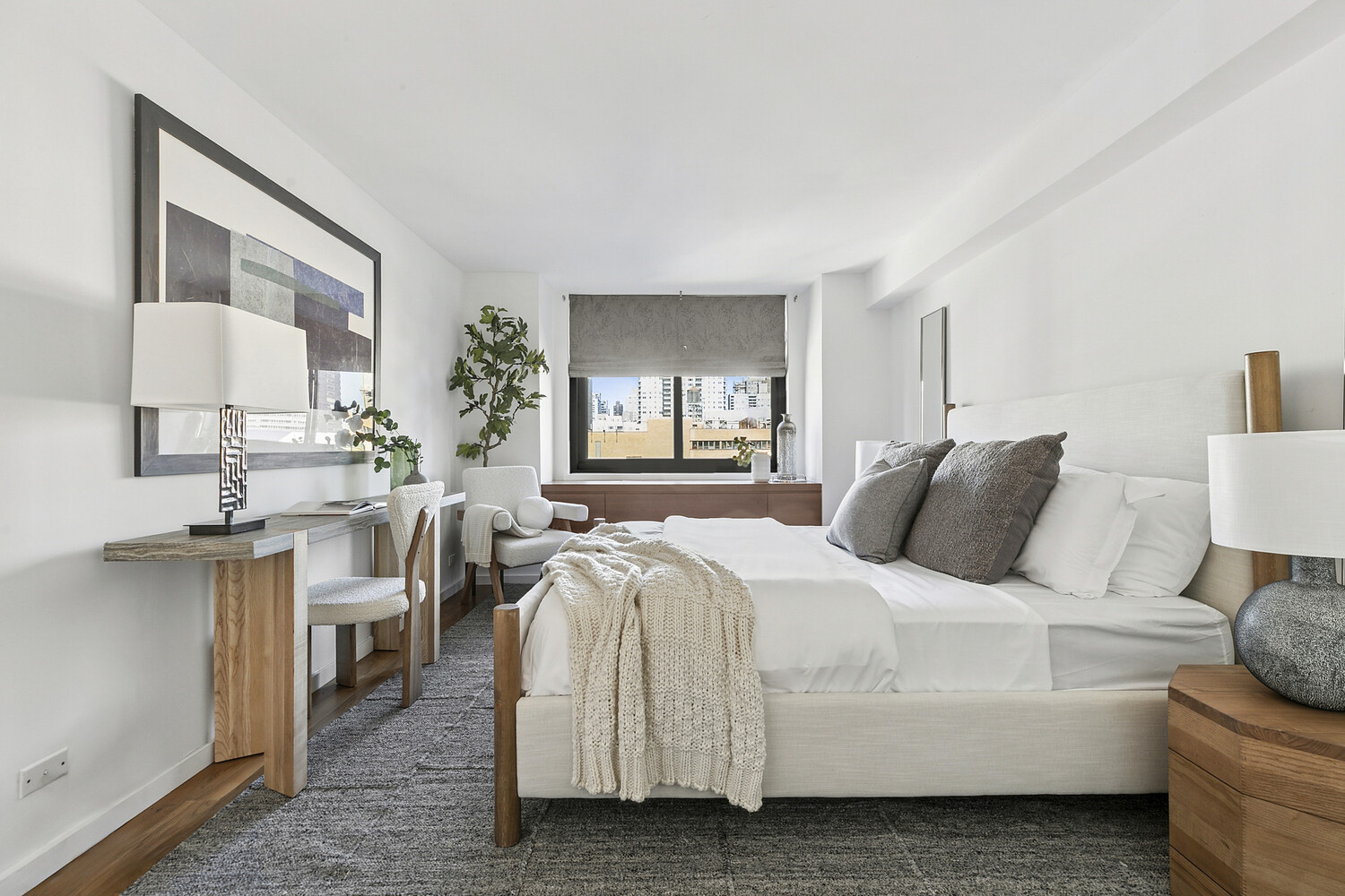 515 East 72nd Street, Unit 11L Manhattan, NY 10021 - Photo 14 of 19 a bedroom with bed a lamp and a large window