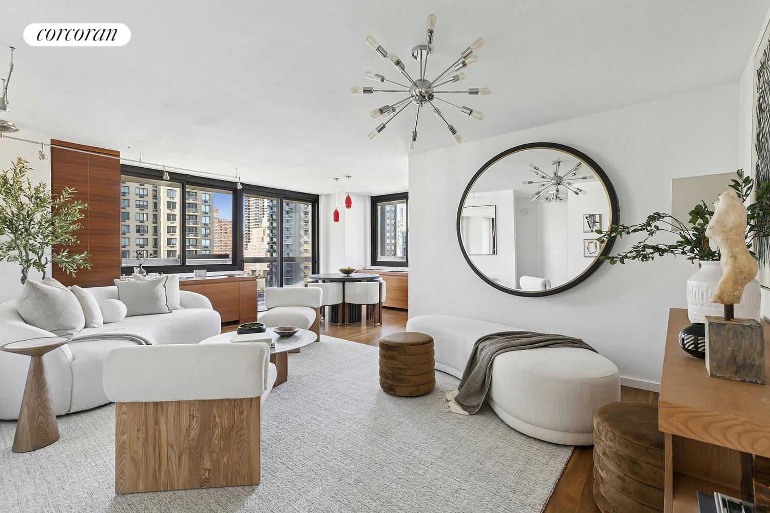 a living room with furniture a mirror and a large window