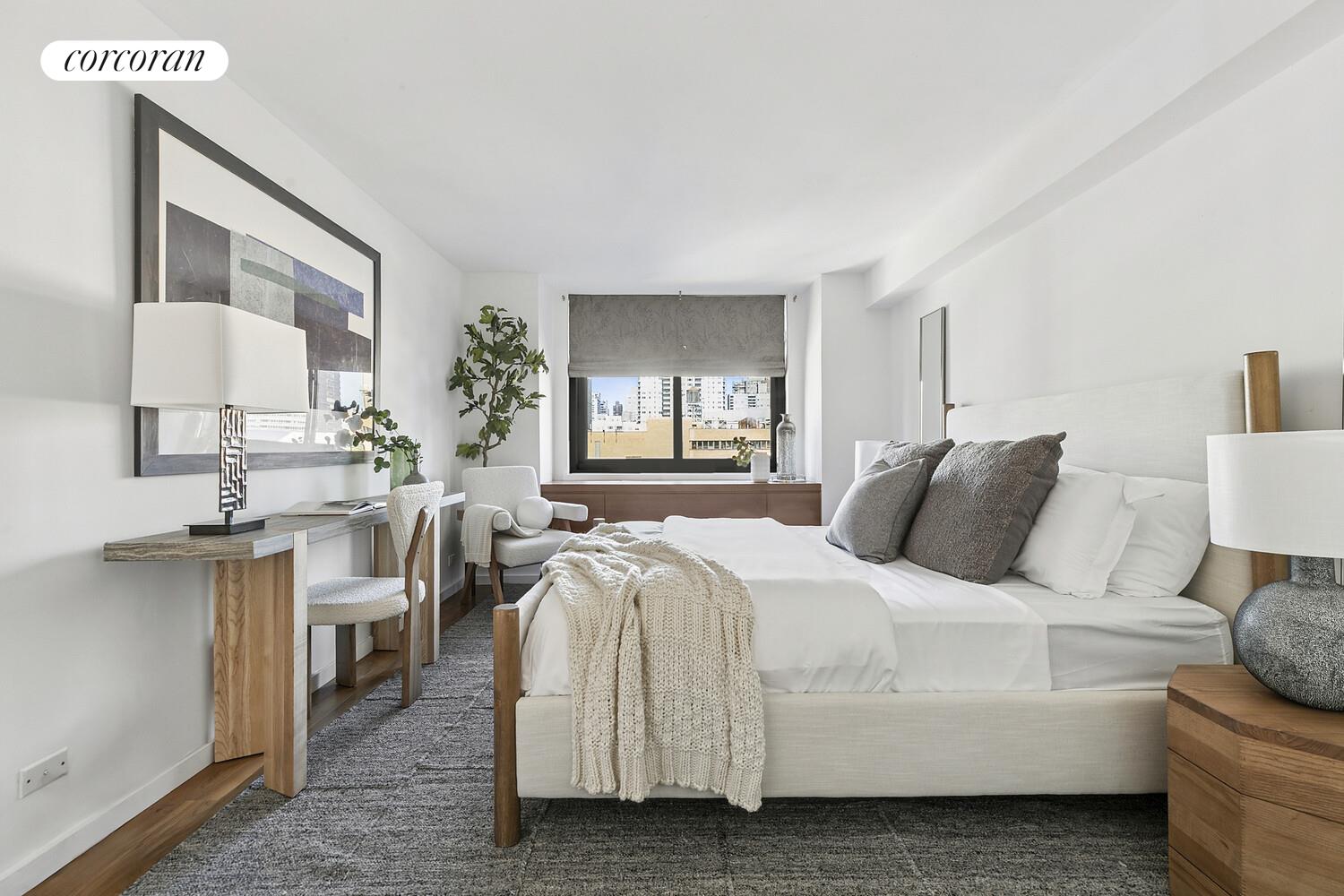 515 East 72nd Street, Unit 11L Manhattan, NY 10021 - Photo 5 of 19 a bedroom with a bed a lamp and a large mirror