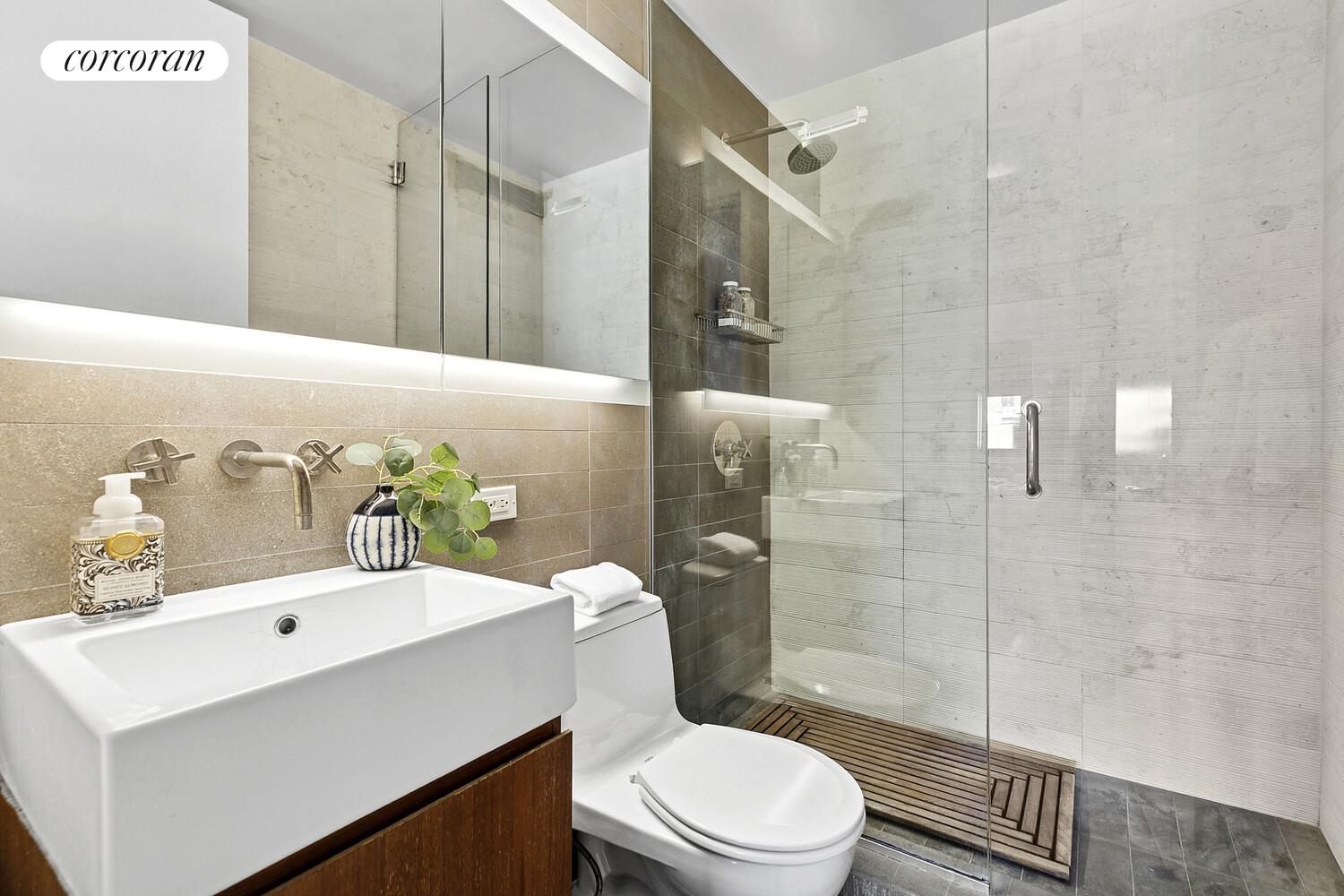 515 East 72nd Street, Unit 11L Manhattan, NY 10021 - Photo 6 of 19 a bathroom with a sink toilet and shower