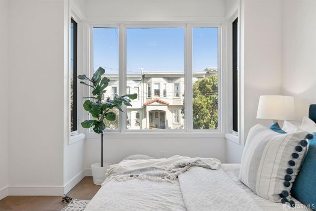 a bedroom with a bed and a window