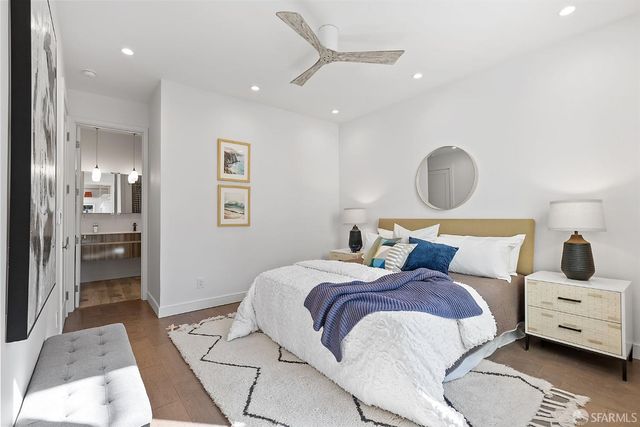 a bedroom with a large bed and a chandelier