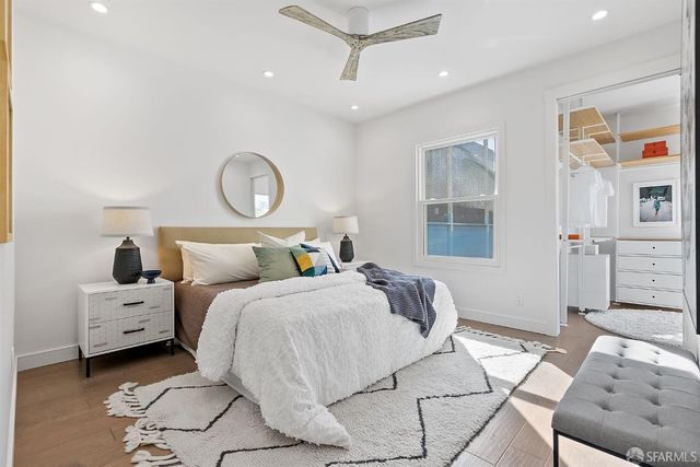 a bedroom with bed and a chandelier
