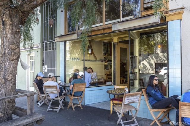 a view of people sitting in front of retail shop