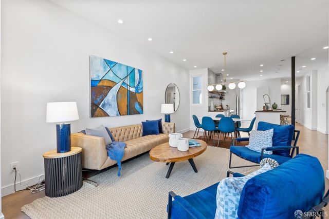 a living room with furniture a rug and a lamp