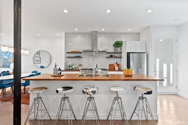 a kitchen with stainless steel appliances granite countertop a sink and cabinets