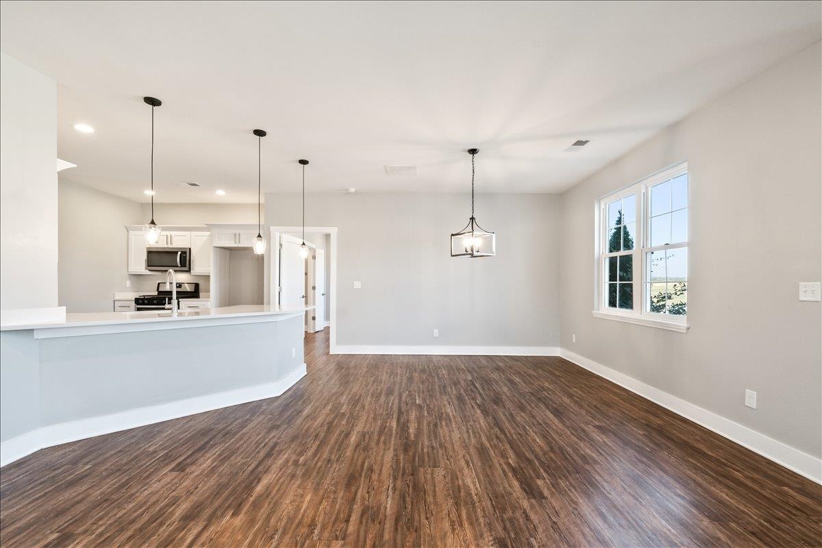 447 Abbey Road, Unit A Munford, TN 38058 - Photo 11 of 30 a view of a kitchen with wooden floor and a window