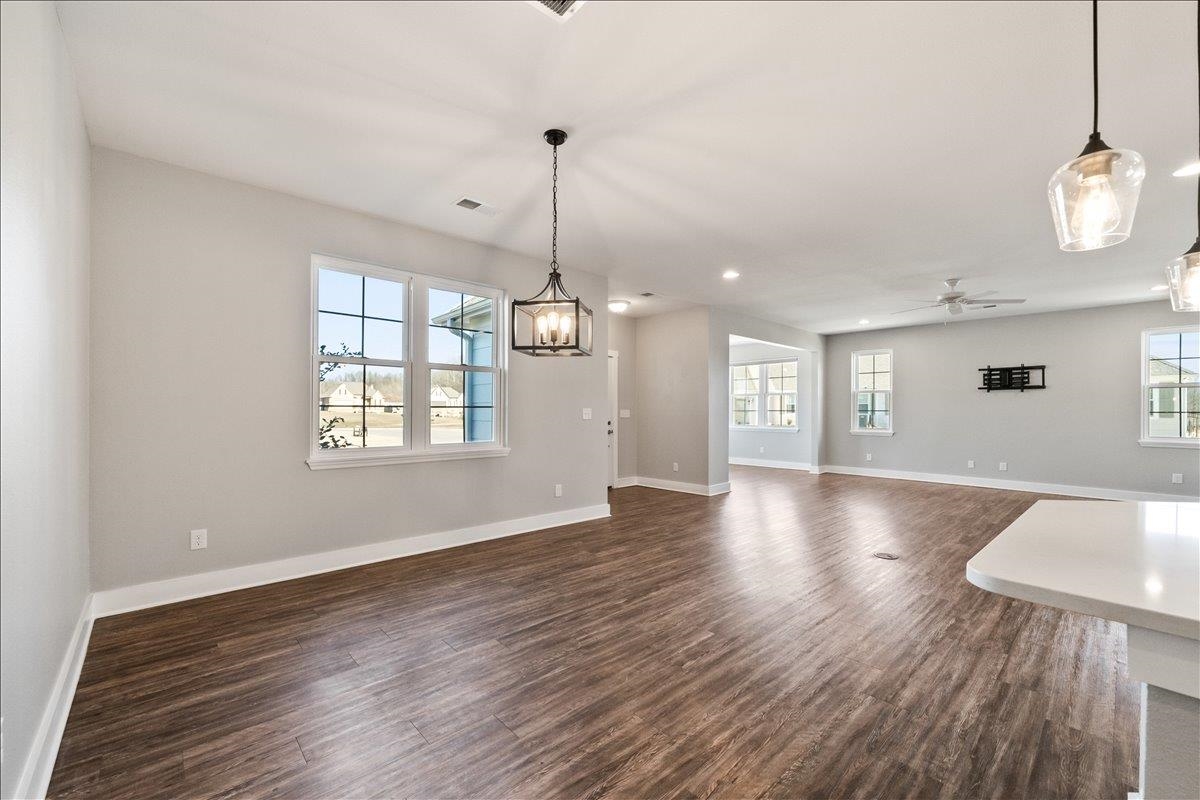 447 Abbey Road, Unit A Munford, TN 38058 - Photo 12 of 30 a view of an empty room with wooden floor and a window