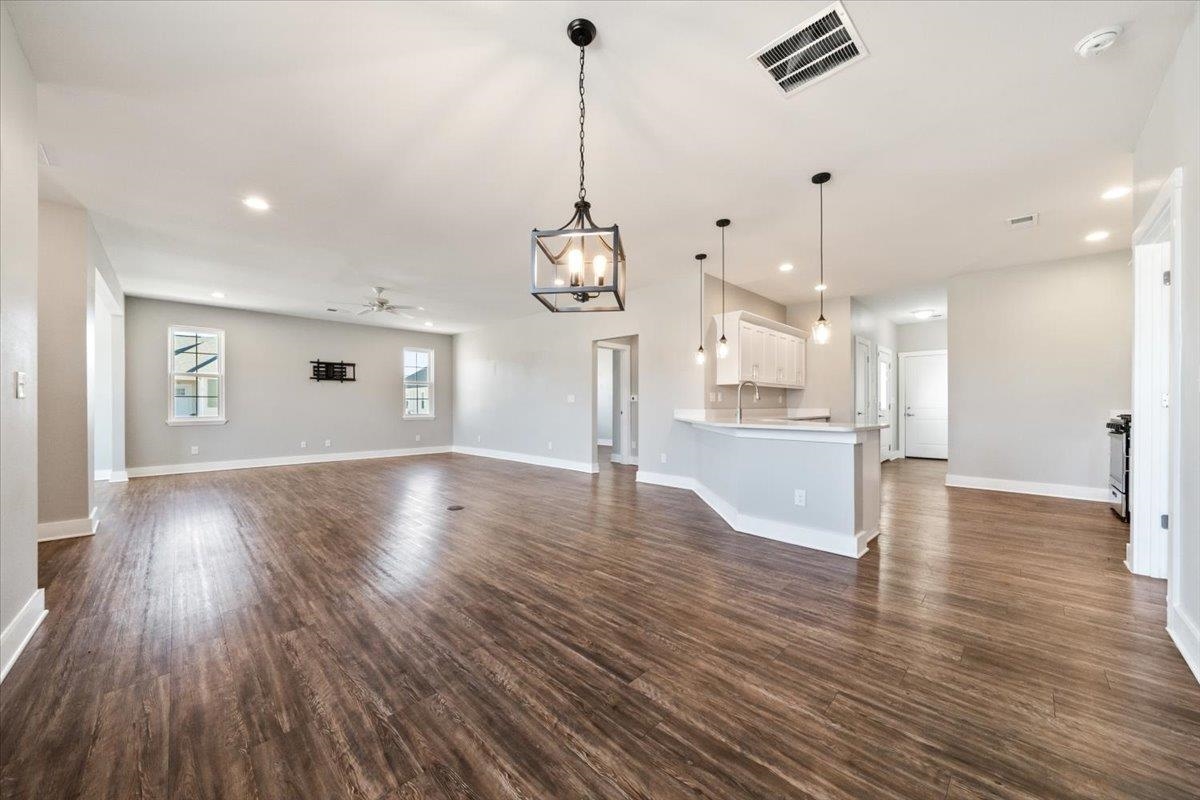 447 Abbey Road, Unit A Munford, TN 38058 - Photo 13 of 30 a view of a room with wooden floor kitchen view and a chandelier