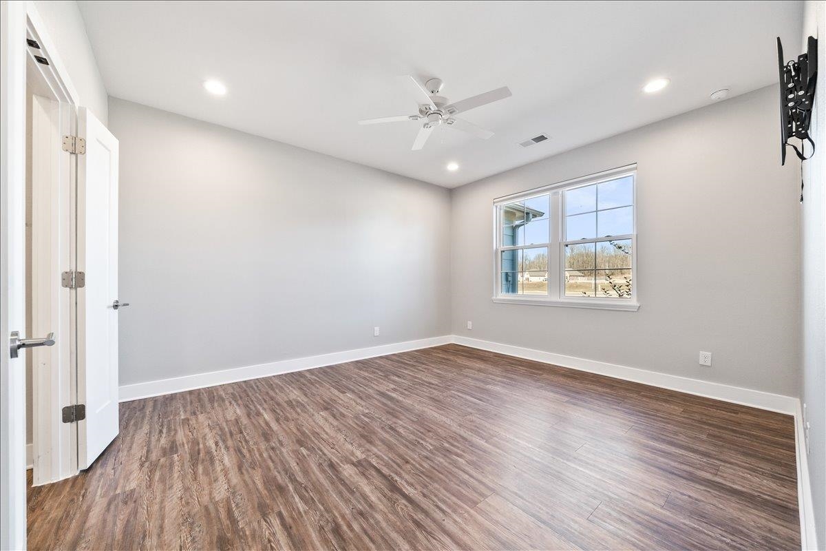 447 Abbey Road, Unit A Munford, TN 38058 - Photo 14 of 30 wooden floor in an empty room with a window