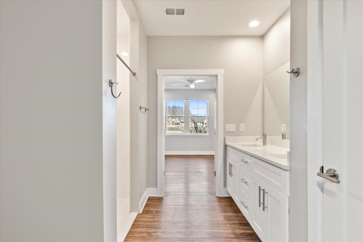 447 Abbey Road, Unit A Munford, TN 38058 - Photo 15 of 30 a bathroom with a double vanity sink and mirror with shower