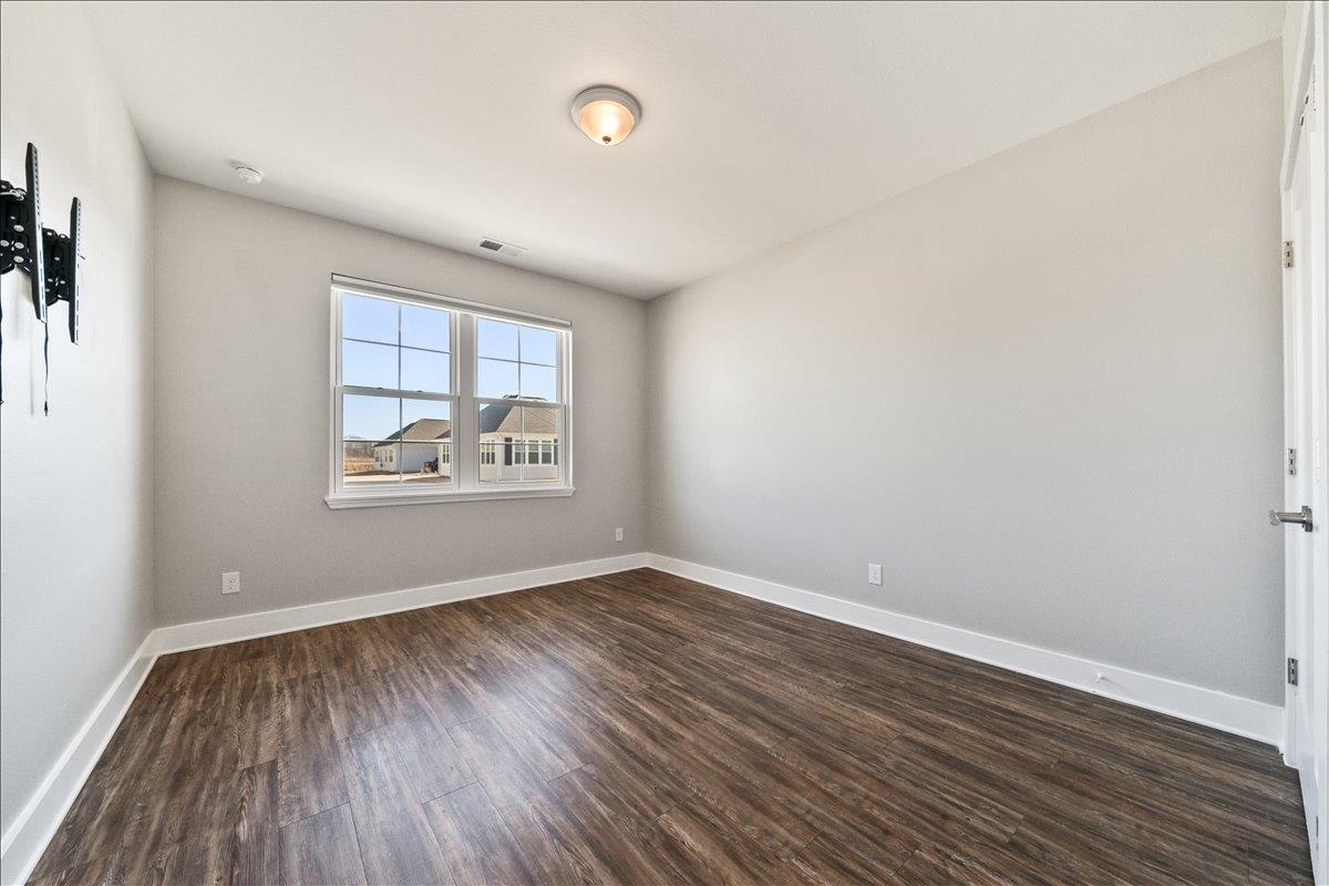 447 Abbey Road, Unit A Munford, TN 38058 - Photo 18 of 30 an empty room with wooden floor and windows