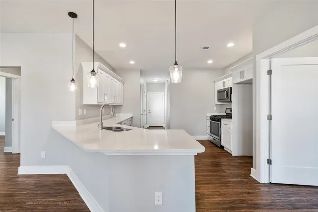 a large kitchen with kitchen island a sink stainless steel appliances and cabinets