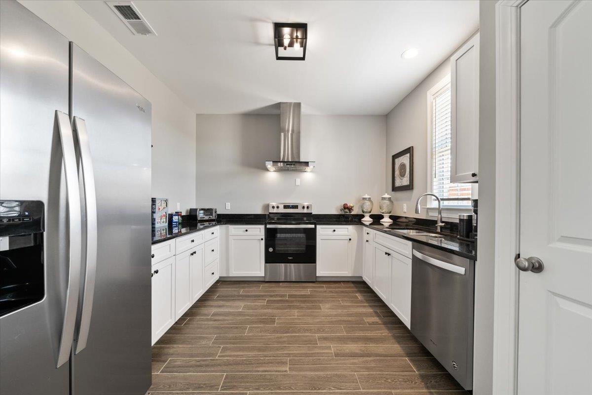 447 Abbey Road, Unit A Munford, TN 38058 - Photo 28 of 30 a large kitchen with cabinets stove top oven and refrigerator