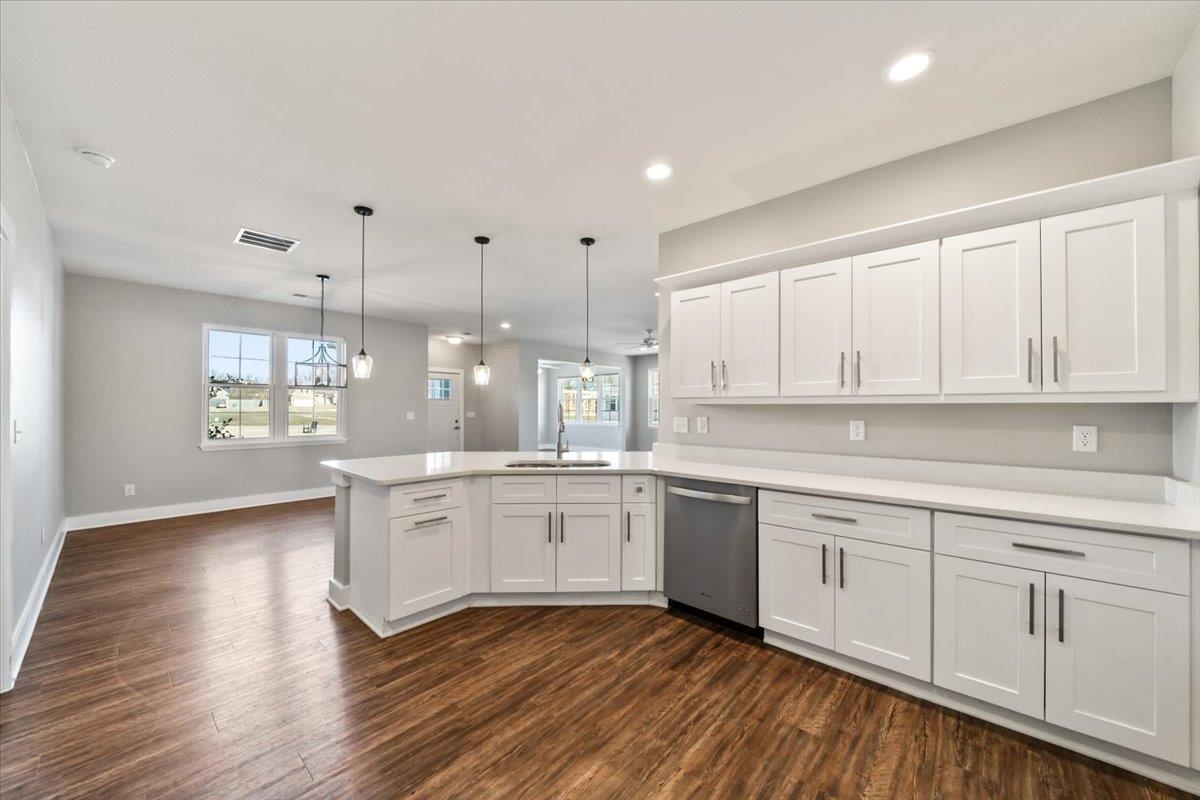 447 Abbey Road, Unit A Munford, TN 38058 - Photo 5 of 30 a large white kitchen with granite countertop white cabinets and wooden floor