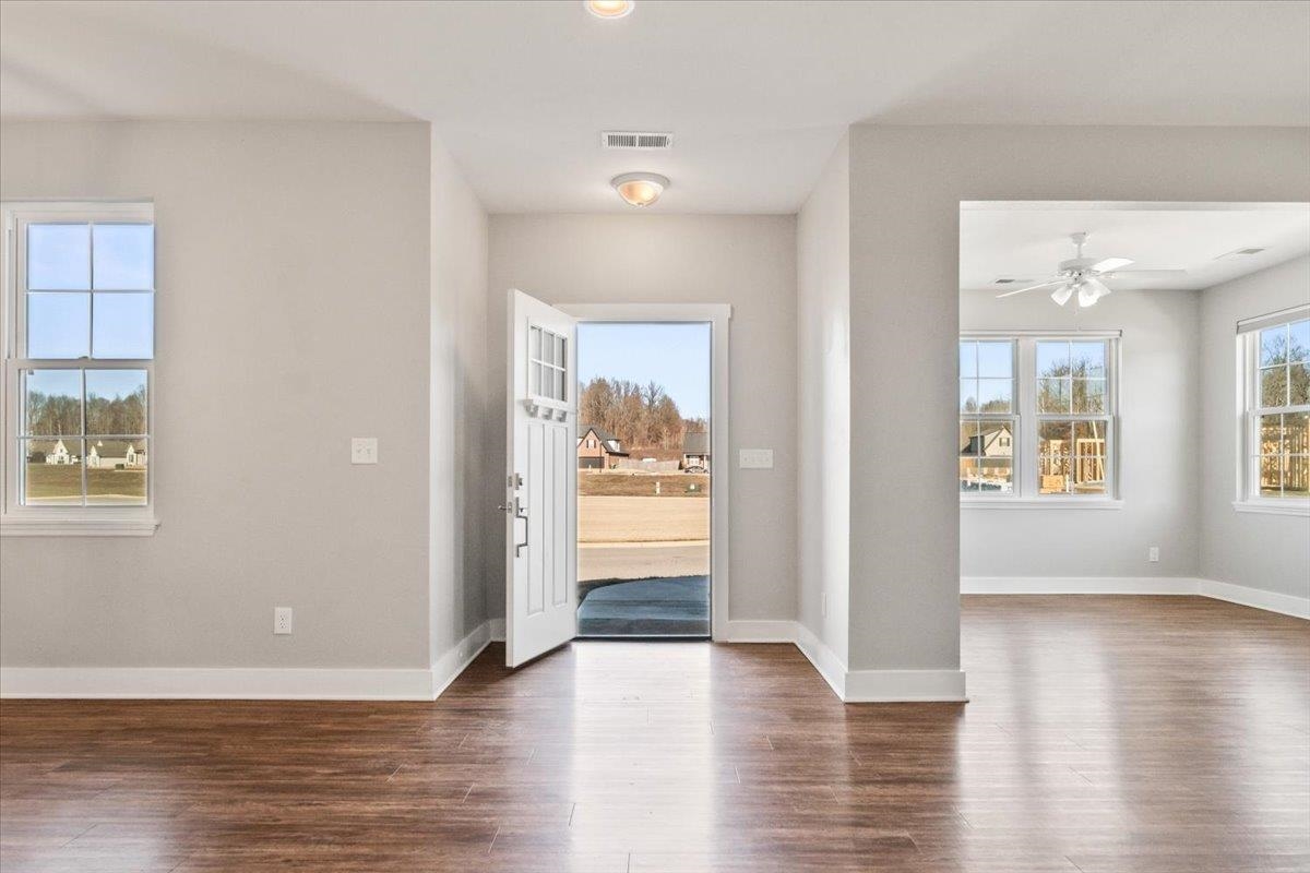 447 Abbey Road, Unit A Munford, TN 38058 - Photo 6 of 30 an empty room with wooden floor and windows