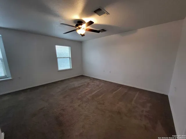 a bathroom with a granite countertop sink a toilet a mirror and shower