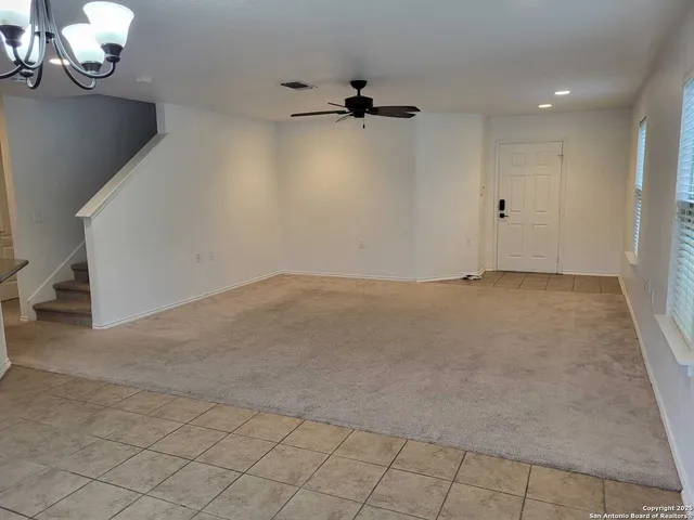 an empty room with a projector space and windows