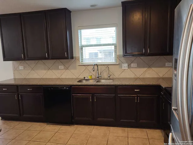 a kitchen with granite countertop cabinets and window