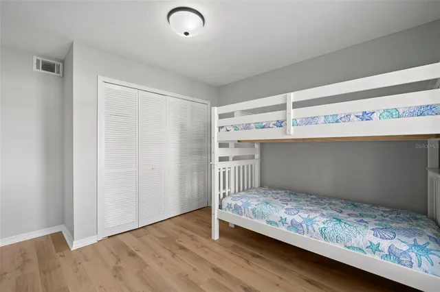 a bedroom with a bed and a cabinet