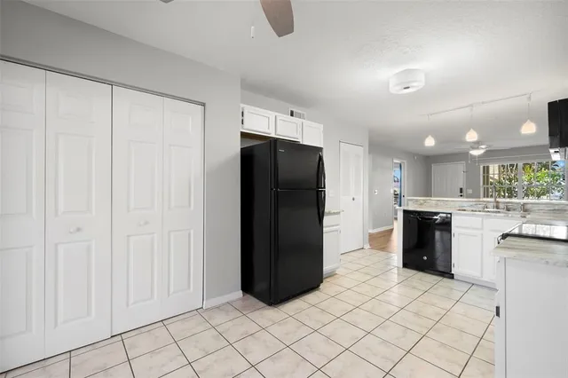 a kitchen with a refrigerator and a stove top oven