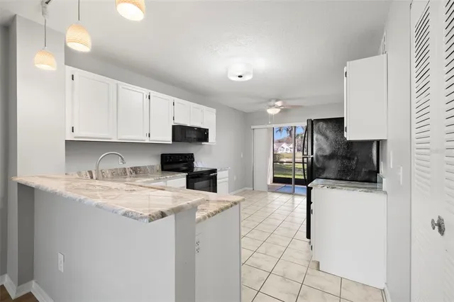 a view of a kitchen with sink stainless steel appliances and cabinets