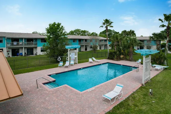swimming pool view with a seating space and a garden view