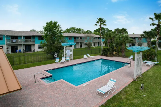 swimming pool view with a seating space and a garden view