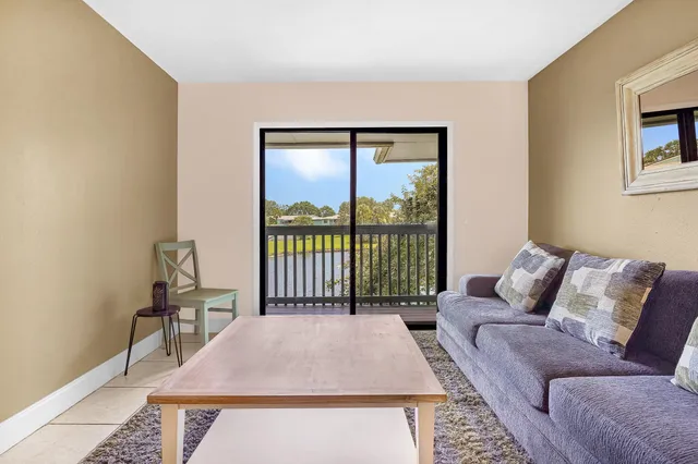 a kitchen with a sink dishwasher a stove and white cabinets with wooden floor