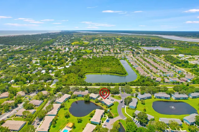 an aerial view of residential houses with outdoor space and swimming pool