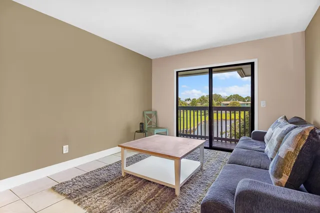a living room with furniture a table and chairs