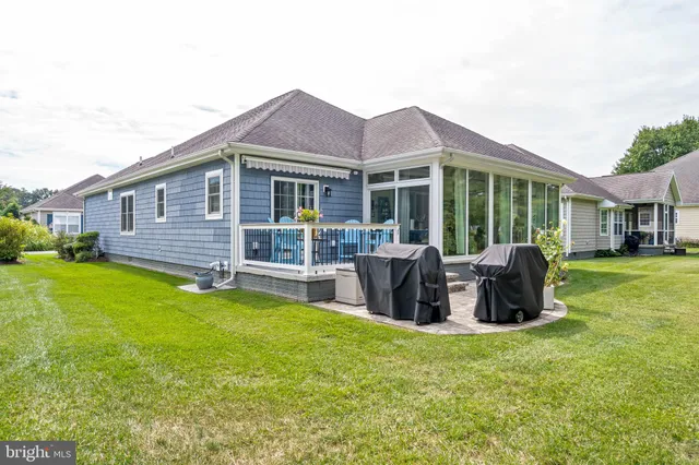 a front view of a house with patio and garden