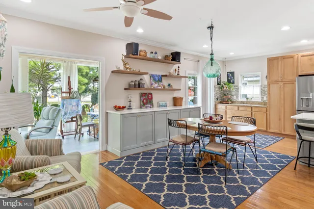a dining room with furniture a rug a potted plant and a chandelier