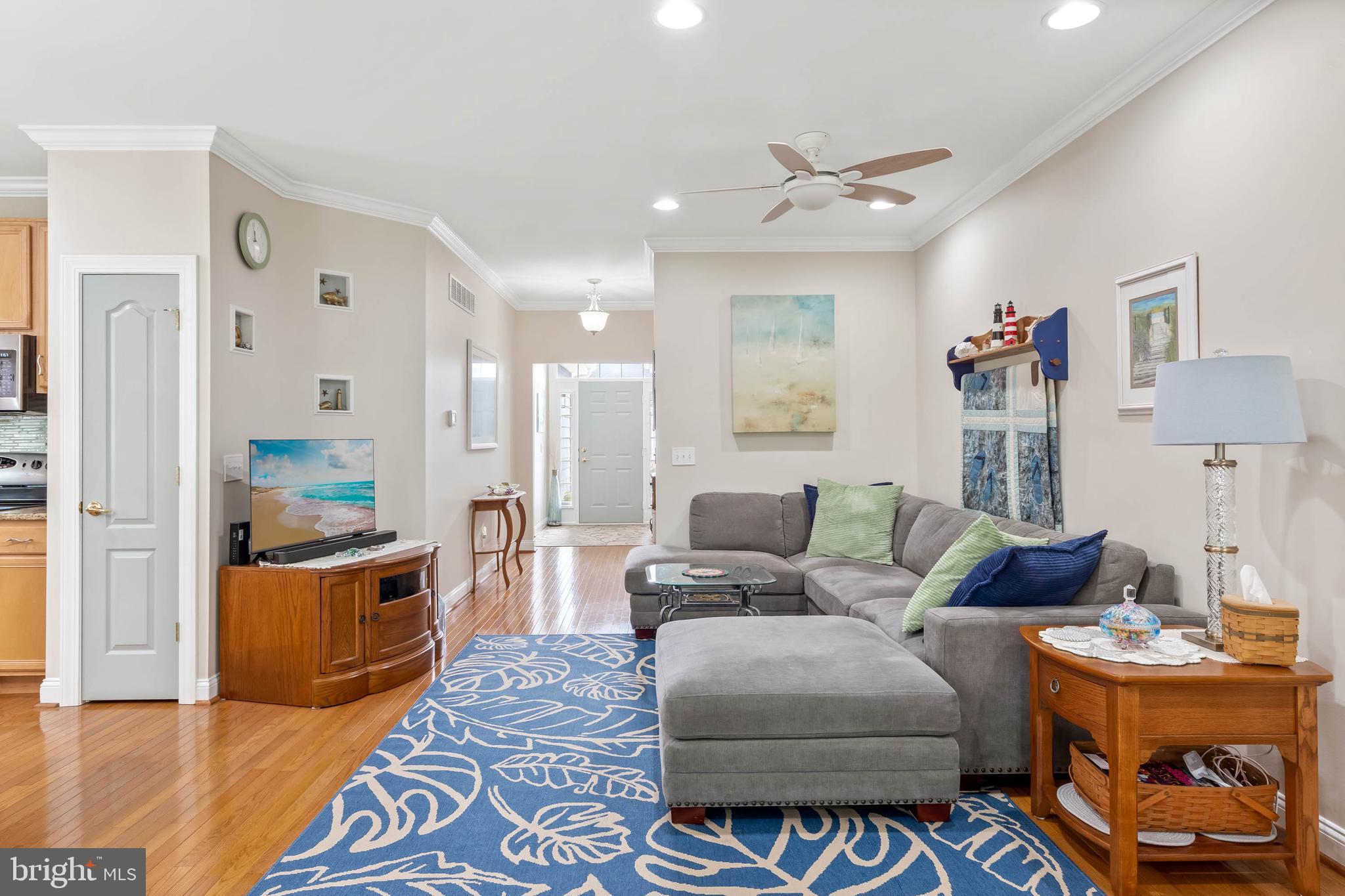 20234 Whitehead Circle, Unit 100 Rehoboth Beach, DE 19971 - Photo 8 of 40 a living room with furniture and a table