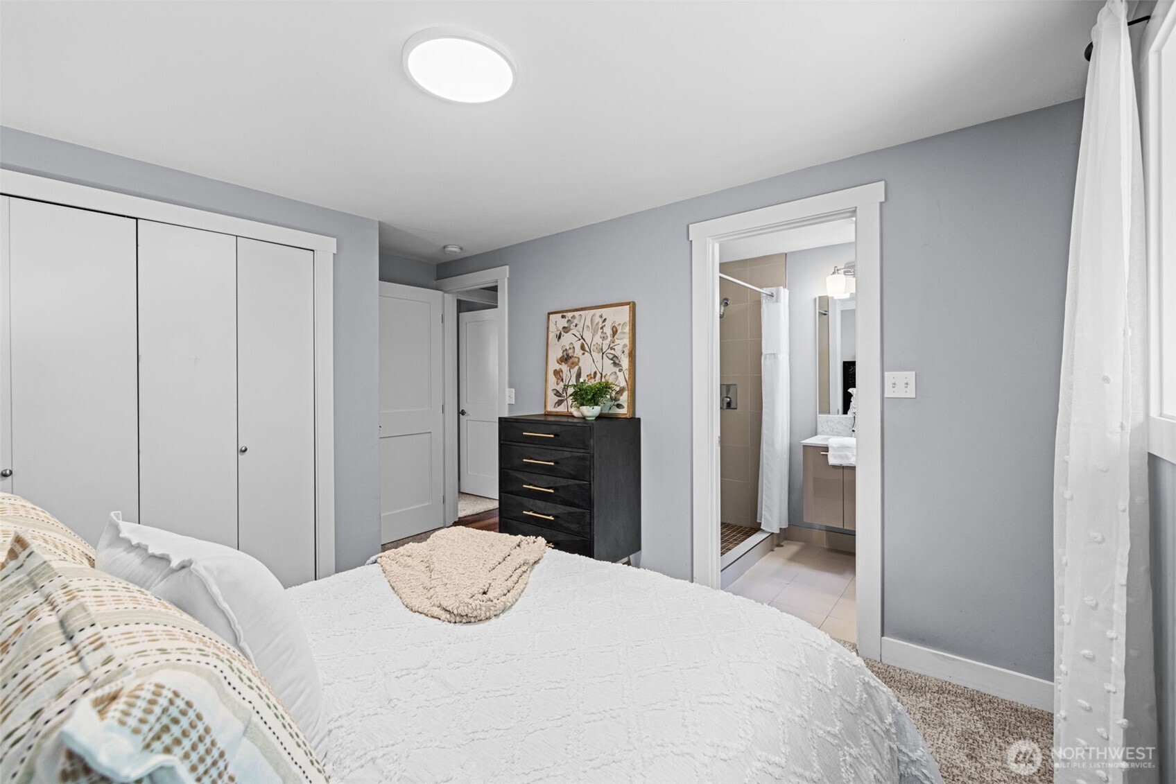 8629 223rd Street Southwest Edmonds, WA 98026 - Photo 18 of 40 a bedroom with a bed and a chandelier