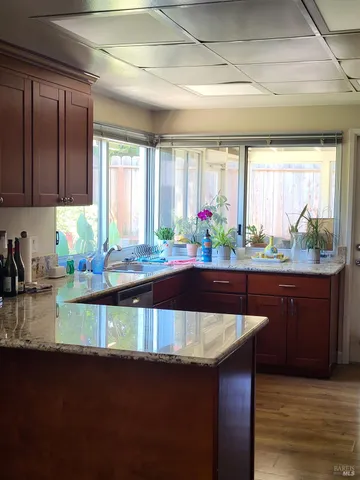 a kitchen with a sink a counter top space and cabinets