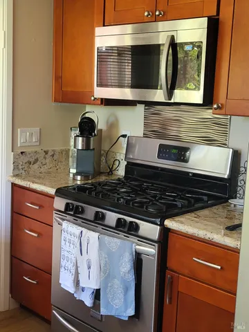 a stove top oven sitting inside of a kitchen