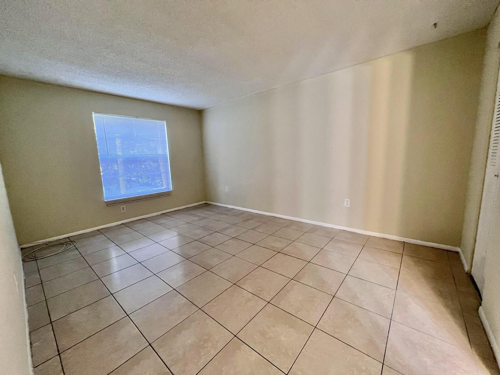 415 Executive Center Drive, Unit 213 West Palm Beach, FL 33401 - Photo 12 of 23 a view of an empty room and a window