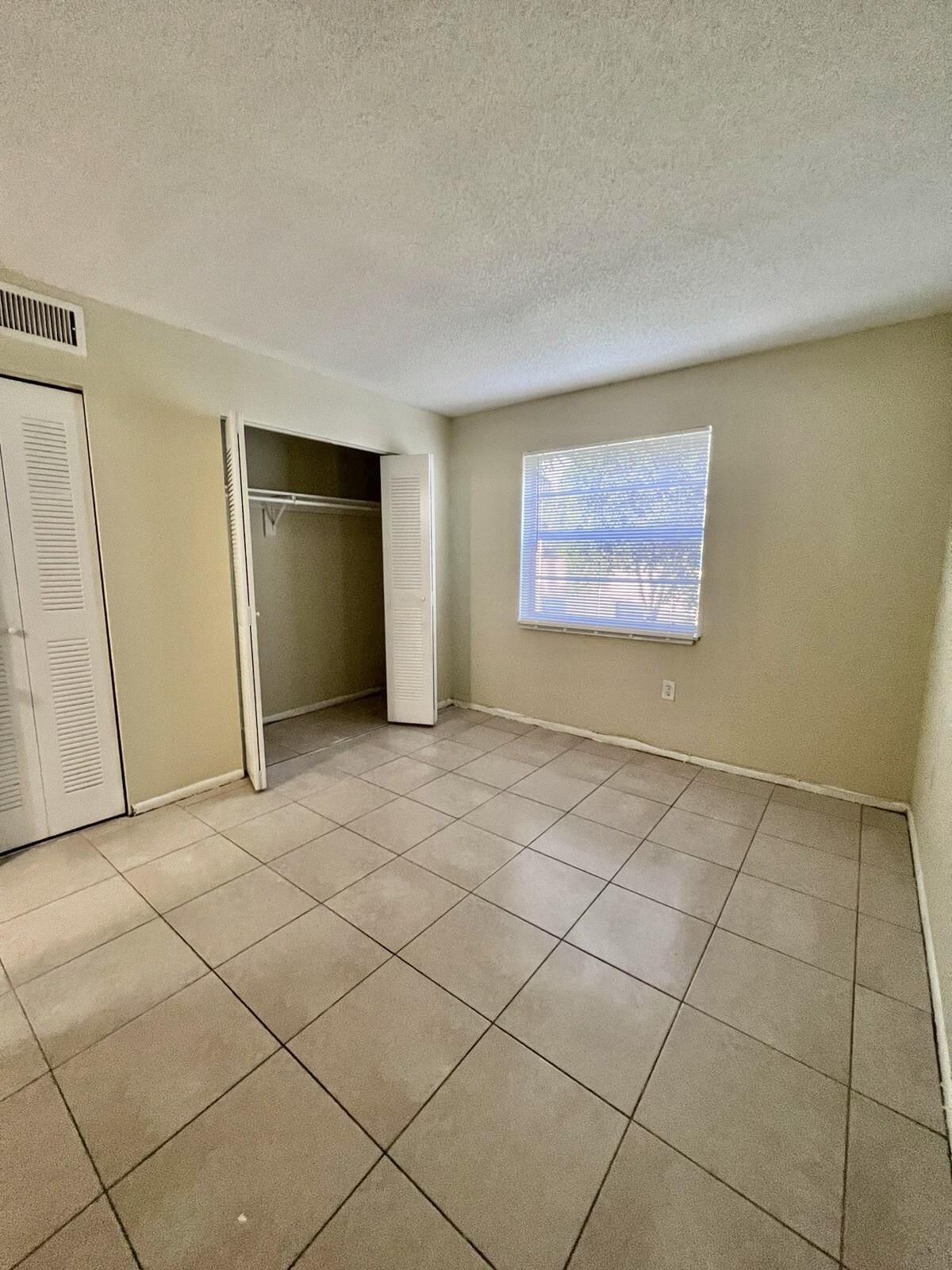 415 Executive Center Drive, Unit 213 West Palm Beach, FL 33401 - Photo 14 of 23 a view of an empty room and window