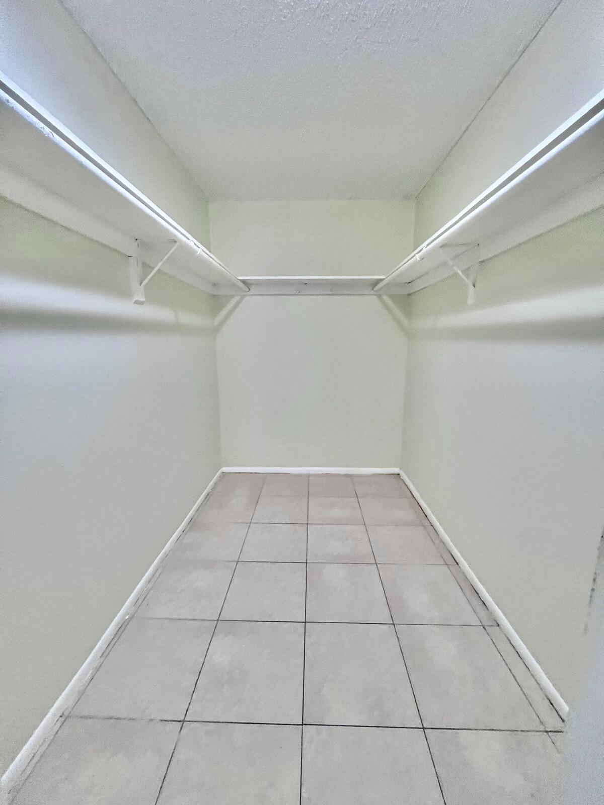 415 Executive Center Drive, Unit 213 West Palm Beach, FL 33401 - Photo 16 of 23 a view of a room with racks on the wall