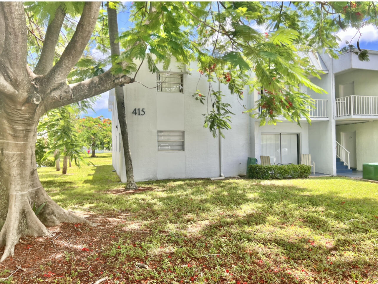 415 Executive Center Drive, Unit 213 West Palm Beach, FL 33401 - Photo 18 of 23 a view of a trees in front of a house
