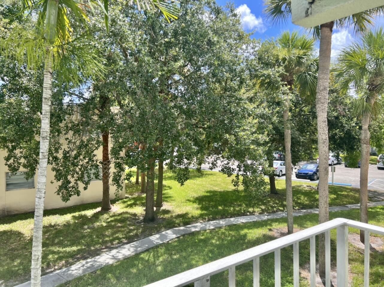 415 Executive Center Drive, Unit 213 West Palm Beach, FL 33401 - Photo 20 of 23 a view of a bench in a garden