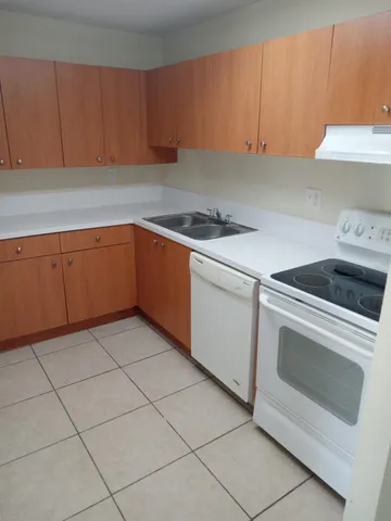 a kitchen with cabinets appliances and a sink
